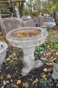 A WEATHERED CONCRETE BIRD BATH, on a shaped separate base, diameter 51cm x height 57cm, condition