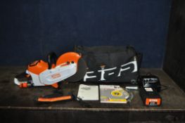 A STIHL TSA230 CORDLESS CUT-OFF SAW with one ap300 battery, charger, manual, two blades, tools and