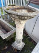 A WEATHERED CONCRETE BIRD BATH, on a tall Corinthian and patterned column, height 81cm, condition