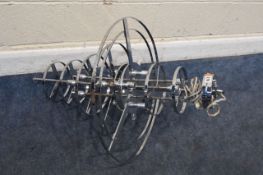 A MODERN METAL HANGING LIGHT, with multiple rings and tiers, approximate height 90cm, condition