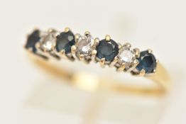 AN 18CT GOLD GEM SET HALF ETERNITY BAND RING, set with four circular cut blue sapphires