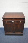 A MAHOGANY CABINET, the removable top with a hinged lid, that’s enclosing a fitted interior, atop