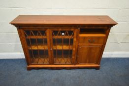 A REPRODUCTION YEW WOOD BOOKCASE, the double glass doors enclosing two shelves, beside a single