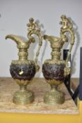A PAIR OF NINETEENTH CENTURY BRASS EWER ORNAMENTS decorated with a moulded putti and dove to the