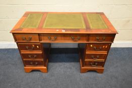 A REPRODUCTION TWIN PEDESTAL DESK, with three green leather writing surfaces, fitted with nine