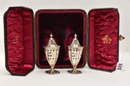 A CASED PAIR OF EARLY 20TH CENTURY SILVER SALTS, containing two vase shape salts with pierced covers