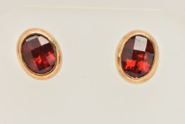 A PAIR OF 9CT GOLD OVAL GARNET SET STUD EARRINGS, collet set with an oval cut faceted garnets, to