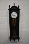 A REPRODUCTION MAHOGANY WALL CLOCK, the arched glass door enclosing an 8 inch brass and enamel dial,