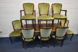 A REPRODUCTION FRENCH WALNUT DINING TABLE, with one additional leaf, serpentine ends, raised on