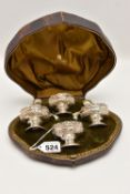 A CASED LATE VICTORIAN SILVER CRUET SET, comprising of four embossed and raised salts,