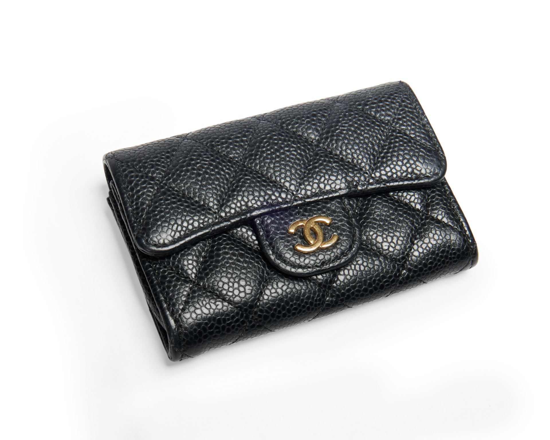 Chanel.  A black caviar leather wallet, with gold hardware and clasped closure, 2020, comes with...