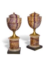 A pair of Derbyshire blue-john ornamental urns, late 18th / early 19th century, with later gilt-b...