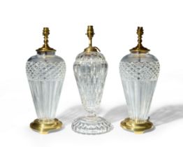 A pair of modern Waterford crystal table lamps together with another moulded glass table lamp, 20...