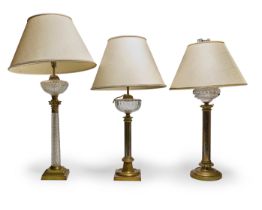 Three column table lamps, of Victorian style, first half 20th century, each with a glass oil rese...