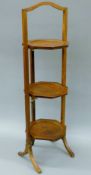 An early 20th century oak three-tier folding cake stand. 85 cm high.