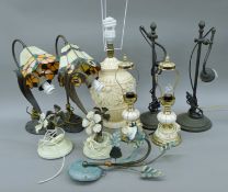 A quantity of various table and hanging lamps. The largest 55 cm high.