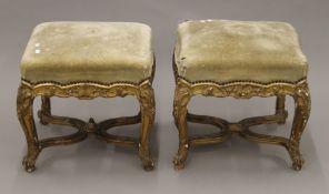 A pair of 19th century French giltwood overstuffed stools. Each 46 cm long.