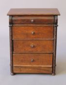 An early 20th century oak miniature chest of drawers. 28 cm wide.