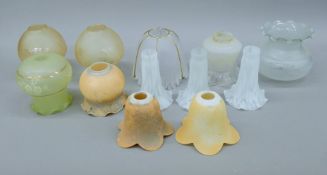 A quantity of glass light shades of various sizes.