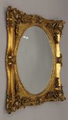 A large modern gilt-framed mirror. 85 x 106 cm.
