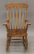 A slat-back rocking chair. 64 cm wide.