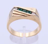 A 14 K gold diamond and emerald gentleman's ring. Ring size T/U.