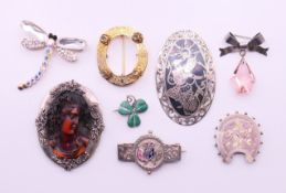 A collection of various brooches, mostly silver to include a Siam brooch,