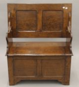 An early 20th century oak monk's bench. 90.5 cm wide. 75 cm high x 45.