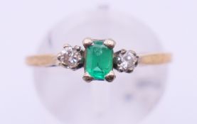 A 9 ct gold, emerald and diamond ring. Ring size N.