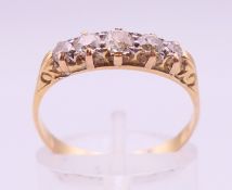An 18 ct gold five-stone diamond ring. Ring size P/Q.