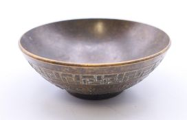 A small Chinese bronze bowl. 5.75 cm diameter.