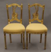 A pair of gilt side chairs. 43 cm wide.