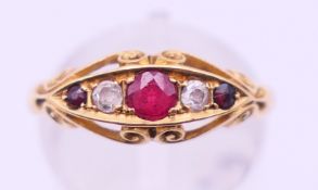 An 18 ct gold, diamond and ruby ring. Ring size N/O.