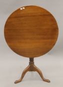 A George III oak tilt-top tripod table. 75 cm diameter.