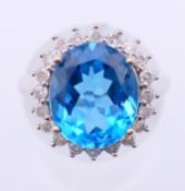 A 9 ct white gold diamond and blue stone ring. Ring size K.