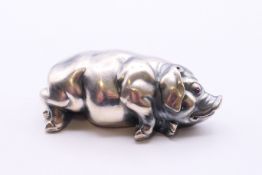 A silver reclining pig bearing Russian marks. 7 cm long.