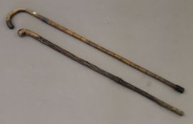 A Victorian silver-mounted walking stick and another. The former 90 cm long.