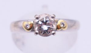 An 18 ct white gold three stone diamond ring. Ring size M.
