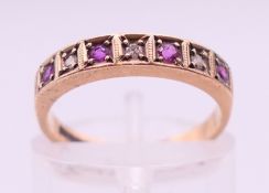 A 9 ct gold, ruby and diamond ring. Ring size J/K.