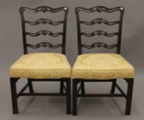 A pair of 19th century ladderback mahogany chairs. 55 cm wide.