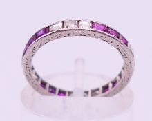 An unmarked ruby and diamond eternity ring. Ring size I/J.