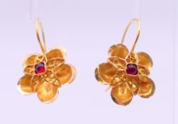 A pair of 14 K gold and ruby earrings. 1.75 cm diameter. 2.7 grammes total weight.