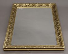 A modern gilt-framed bevelled mirror. 103 x 74 cm.