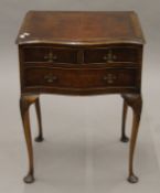 An early 20th century walnut three-drawer side table. 53 cm wide.