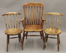 A Victorian splat back open armchair and two stick back kitchen chairs. The former 60 cm wide.