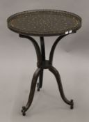A Regency-style circular tripod table. 56 cm diameter.
