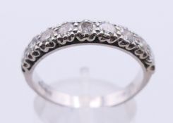 An 18 ct white gold and diamond nine stone diamond ring. Ring size T.