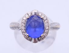 An 18 K white gold, diamond and tanzanite ring, marked D 0.40 and TZ 2.54. Ring size O.