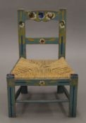 A florally-painted child's chair. 43 cm wide.