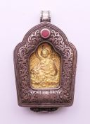 A Tibetan icon pendant. 5 cm high.